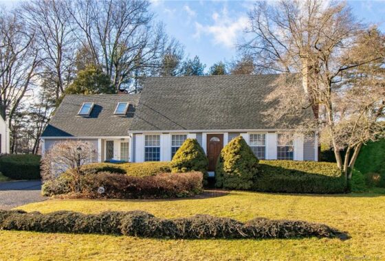 Suburban house with front yard and trees.