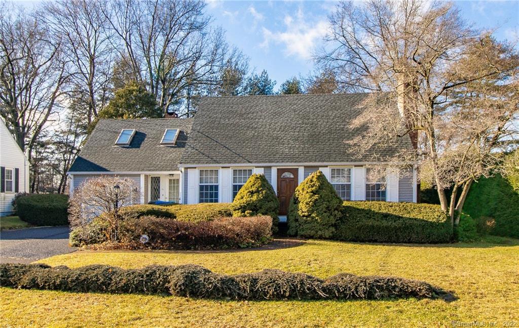Suburban house with front yard and trees.