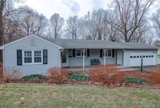 Single-story house with front porch and garage.