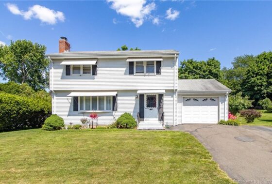 White two-story house with attached garage.