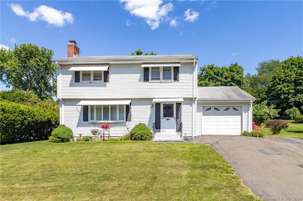White two-story house with attached garage.