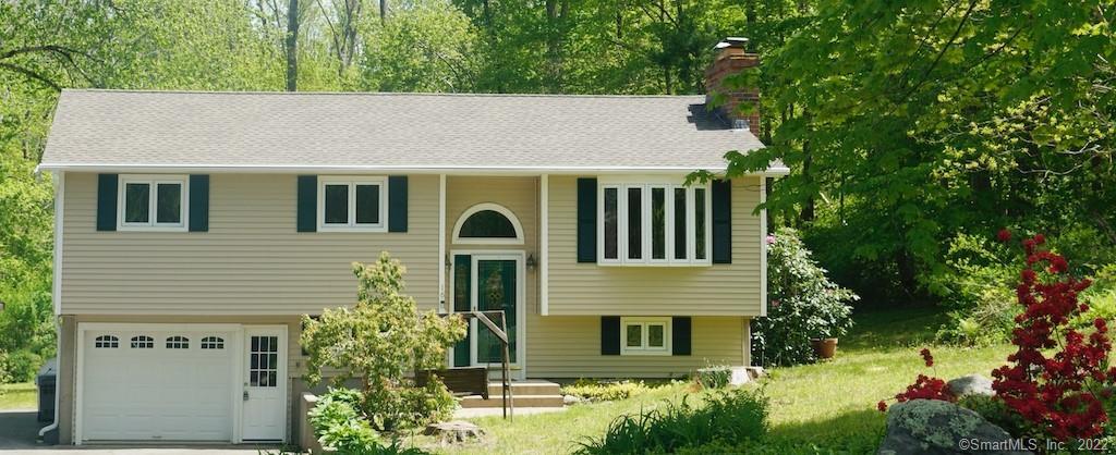 Suburban house with trees and garden.