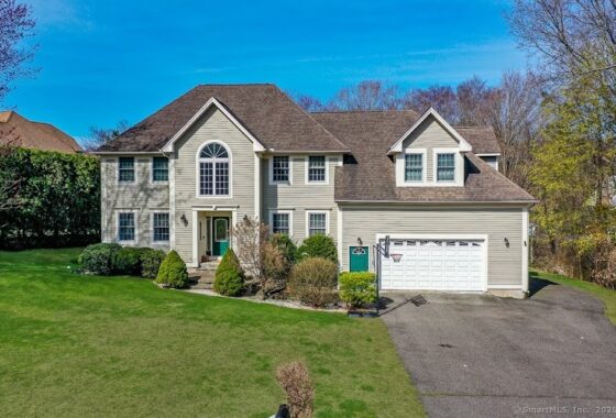 Elegant two-story suburban house with stone and siding exterior.
