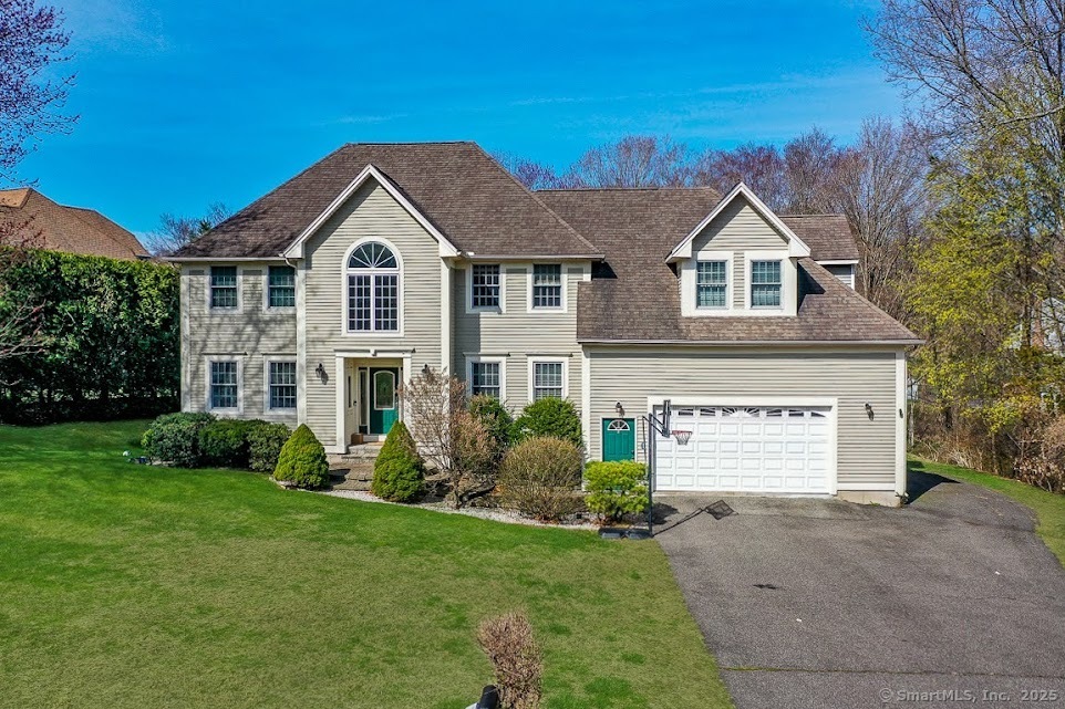 Elegant two-story suburban house with stone and siding exterior.