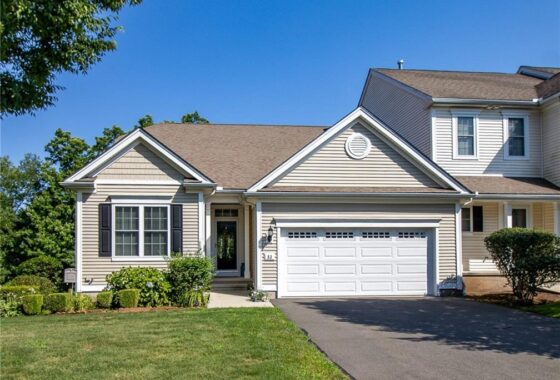 Single-story suburban house with a well-kept lawn and attached garage.