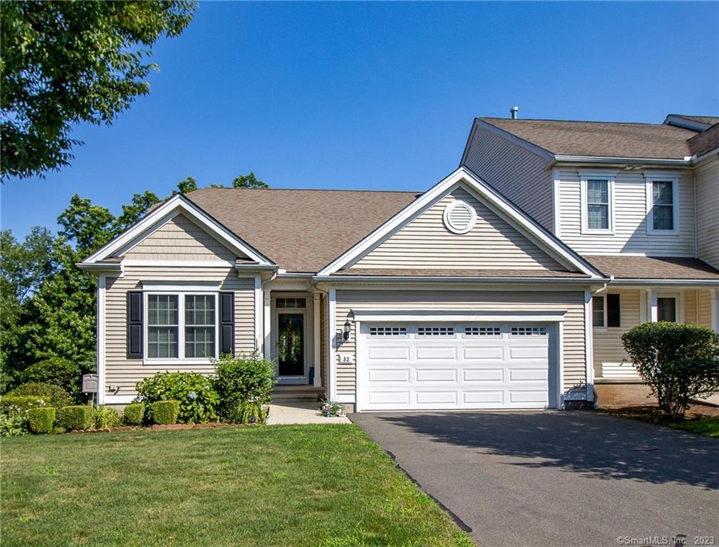 Single-story suburban house with a well-kept lawn and attached garage.