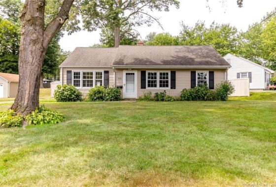 Cozy single-story house with gray siding and black shutters.