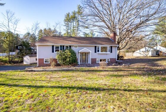 Single-story suburban house with a brick foundation and large front lawn.
