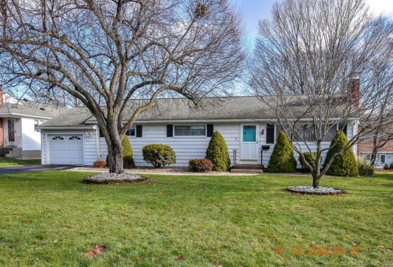 Single-story suburban house with a well-maintained front yard and bare trees.