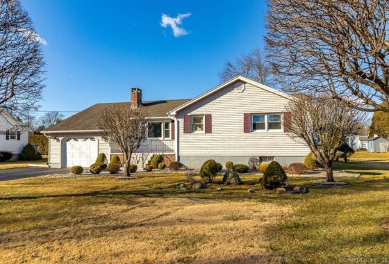 Single-story suburban house under clear blue sky.
