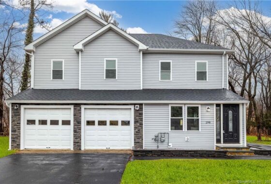 Modern two-story house with gray siding and a three-car garage.